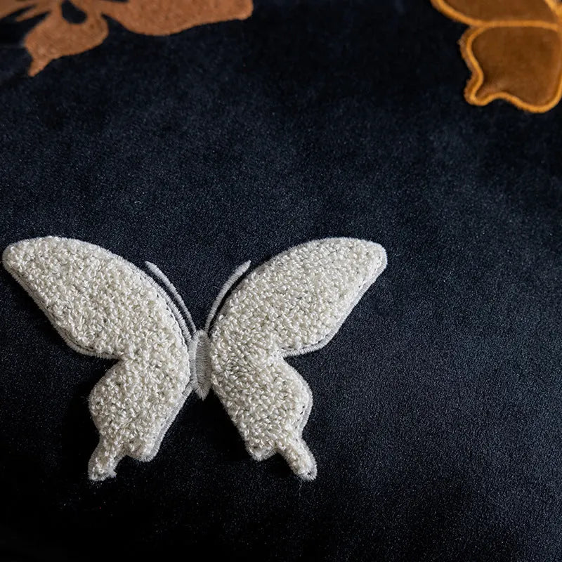 Square beige cushion with detailed purple and black butterfly embroidery in a Chinese floral pattern.