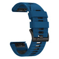 Two-tone quick release silicone strap for Garmin Fenix watch next to a watch case.