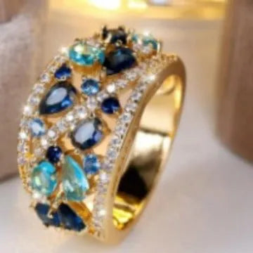 Women's hollow round copper fashion ring showing gold and platinum finish options with white and blue stone effects