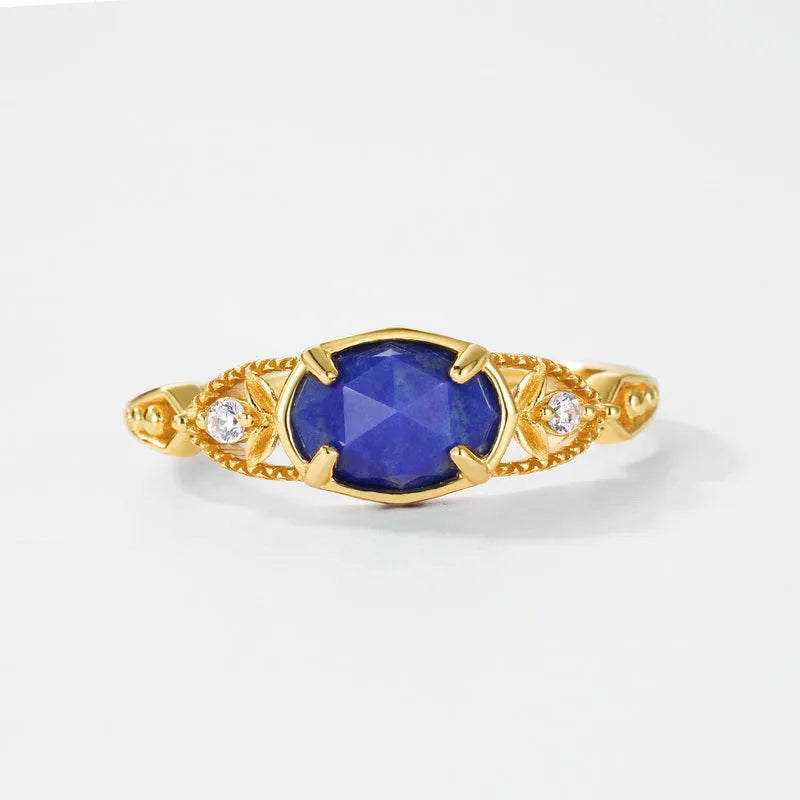 Geometric silver women's ring with a blue oval lapis lazuli gemstone.