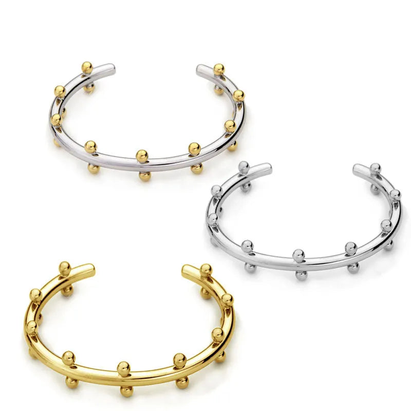 Stainless steel C-shaped bean beads with texture rivet detail in gold, steel, and steel gold colours.