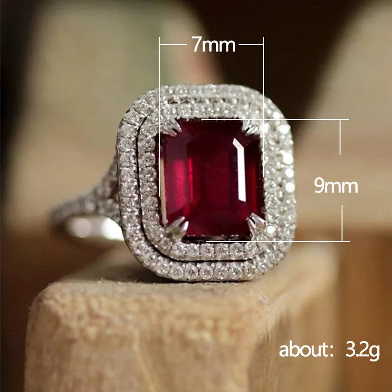 Women's red copper square ring with rhinestone geometric design on a finger.