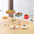 White plastic cube dessert display stand with stackable units for tiered cake and pastry presentation