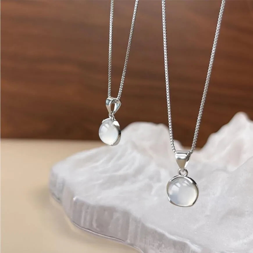 Women's oval pendant necklace with artificial crystal and eight-point star on adjustable silver-toned chain