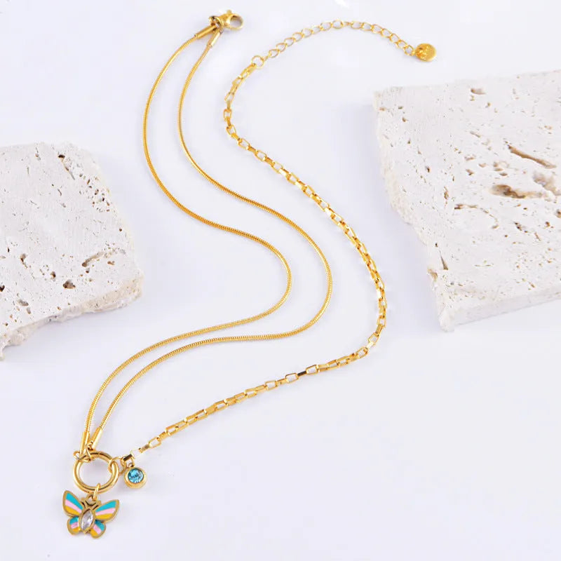 Gold colour epoxy butterfly jewellery set with titanium steel necklace and bracelet showing snake bones chain style