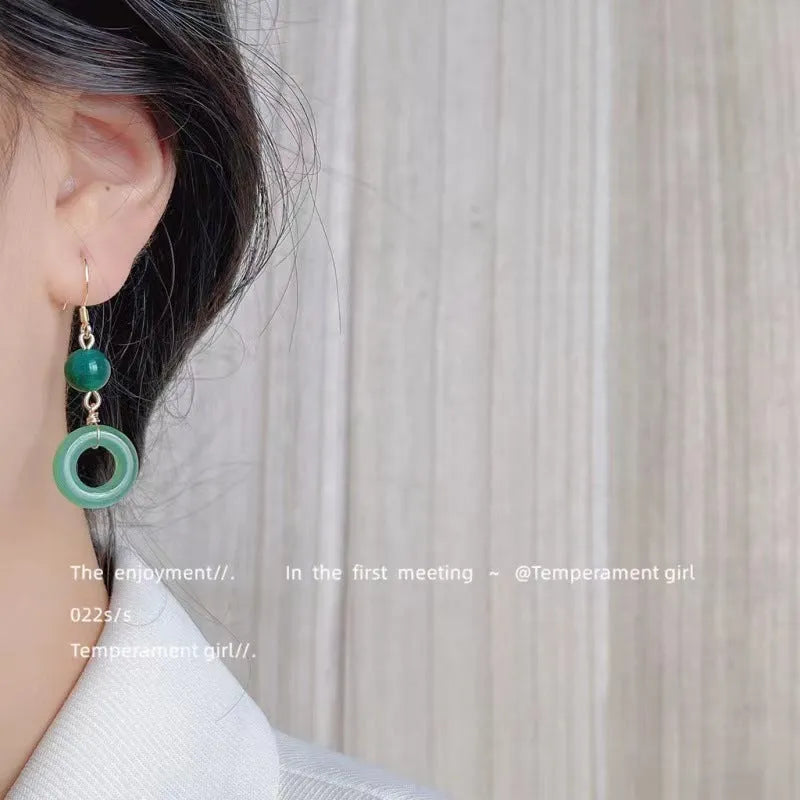 Green Chinese cheongsam peace buckle shape earrings with geometric design elements