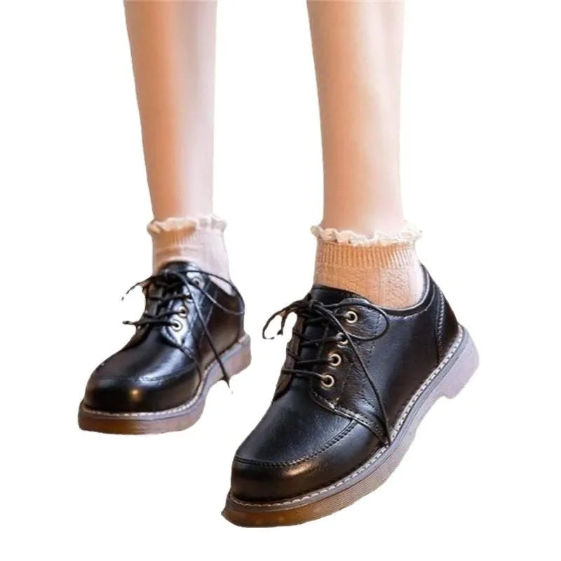 Women's black retro Mary Jane pumps with front lace-up and low square heel on a white background.