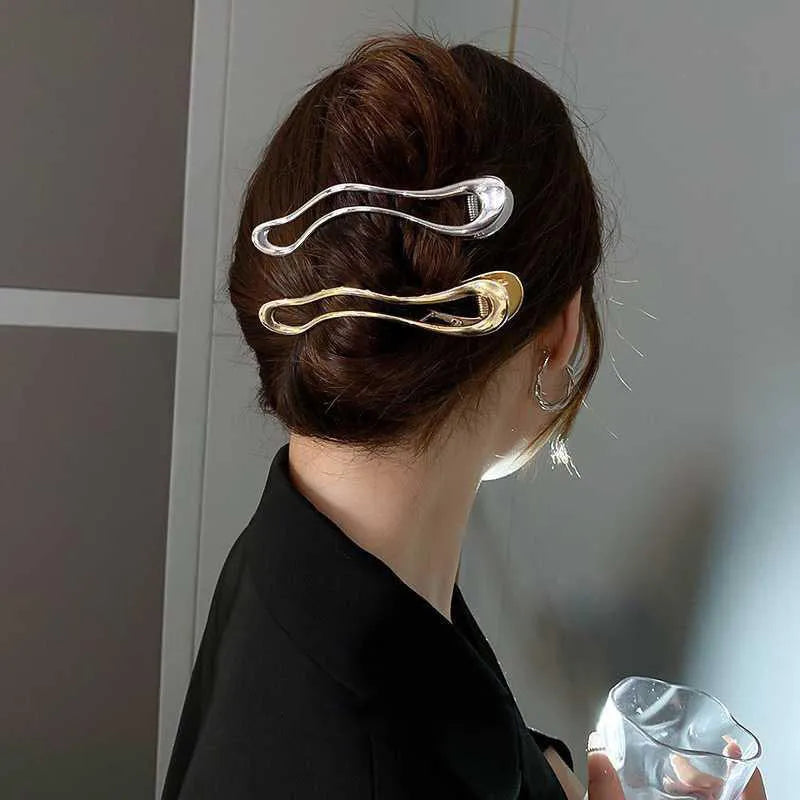 Gold and silver zinc alloy hair barrettes showing arc, square, and triangle shapes on a white background.