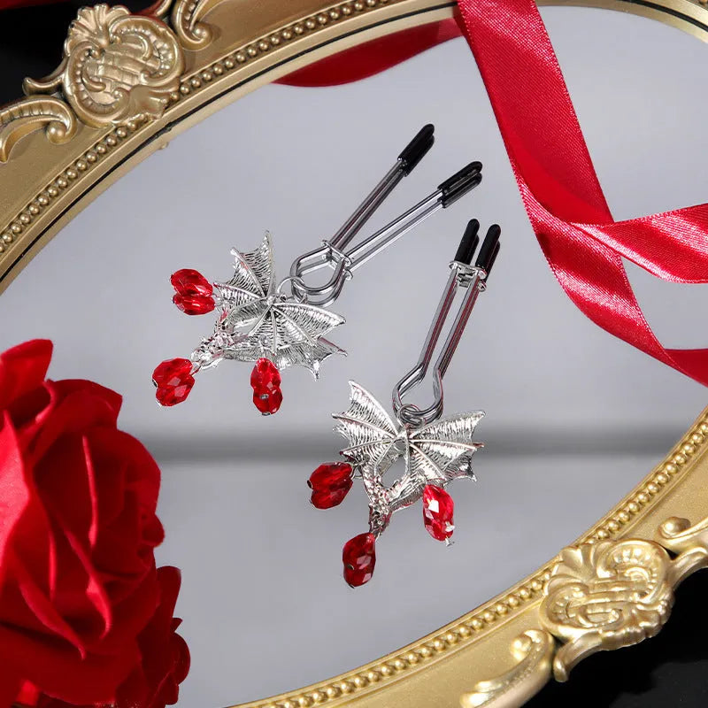 Silver alloy bat nipple clamp with red ruby bat clip decoration.