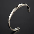 Open-ended stainless steel bracelet for women with inlaid zircon, shown in gold colour finish.