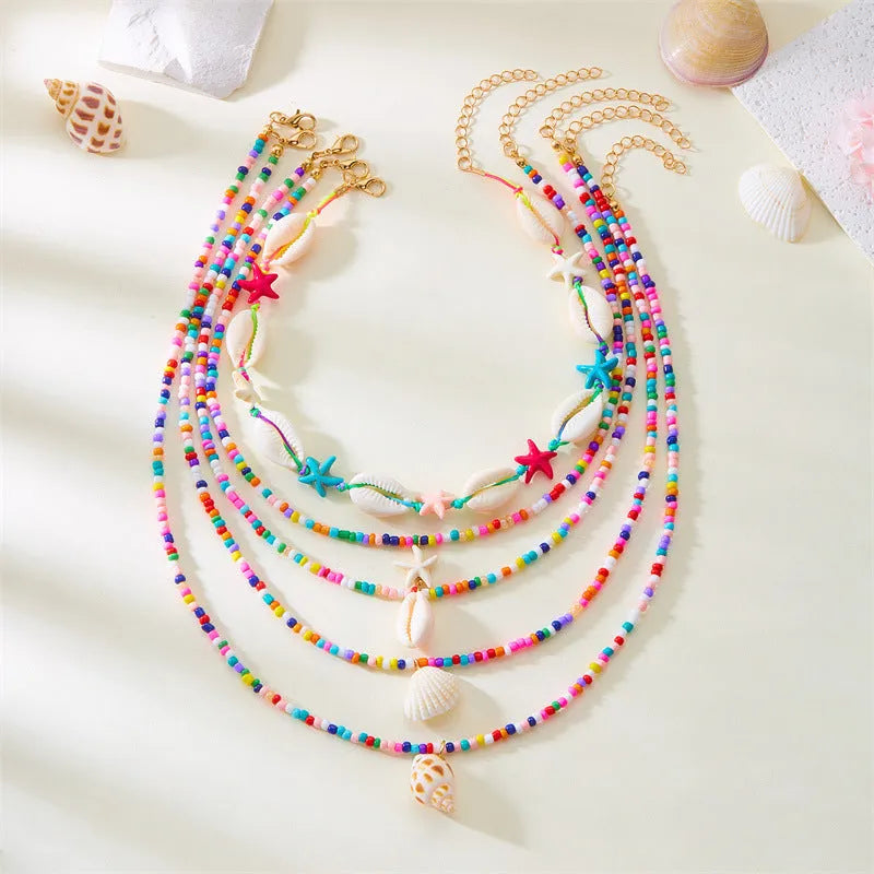 Five-piece women's necklace set with starfish shell and conch bead designs on electroplated alloy
