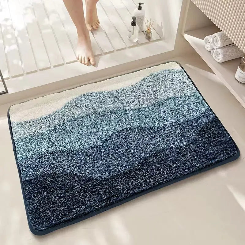 Square cashmere-style floor mat with rainbow pattern on Sky Sea background showing plastic dirt-resistant bottom