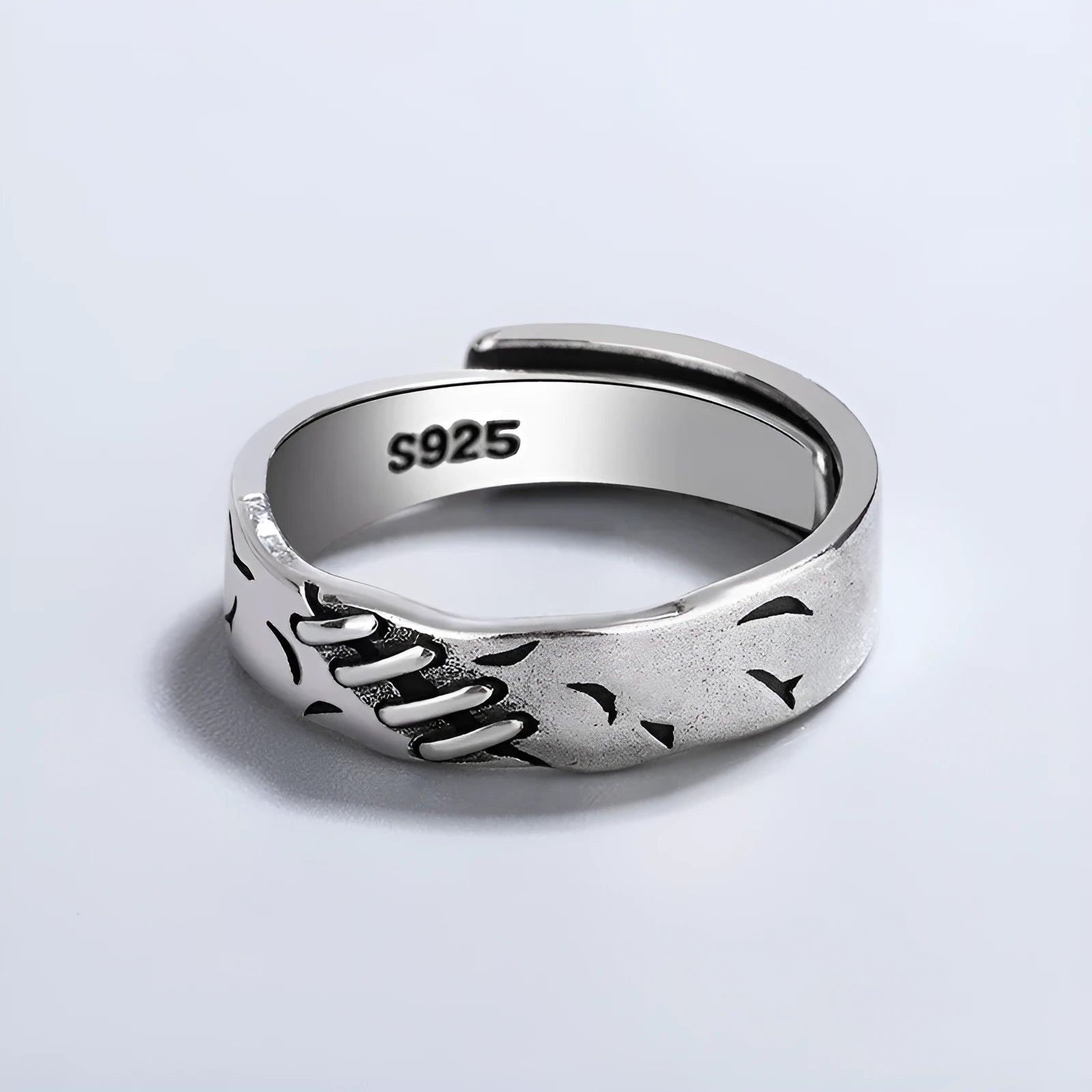 Black geometric copper ring with adjustable opening, showing round and oval design elements