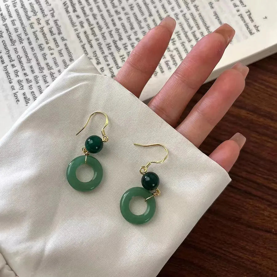 Green Chinese cheongsam peace buckle shape earrings with geometric design elements