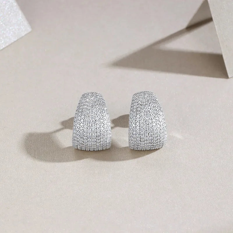 A pair of geometric sterling silver ear studs with moissanite stones for women.