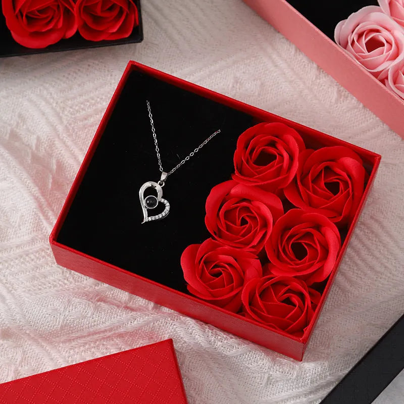 Six red soap flower roses in a black gift box with decorative handbag for Valentine's Day presents.