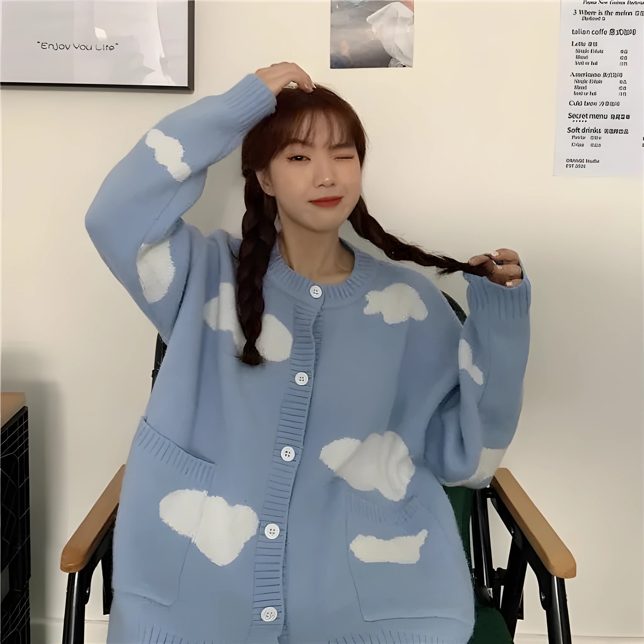 Blue women's loose spandex cardigan with white cloud pattern, worn open.