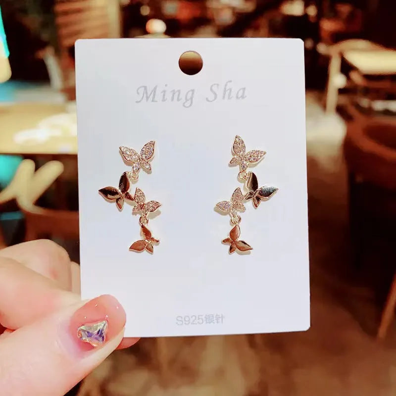 Copper butterfly earrings with four gold-colour charm drops for women