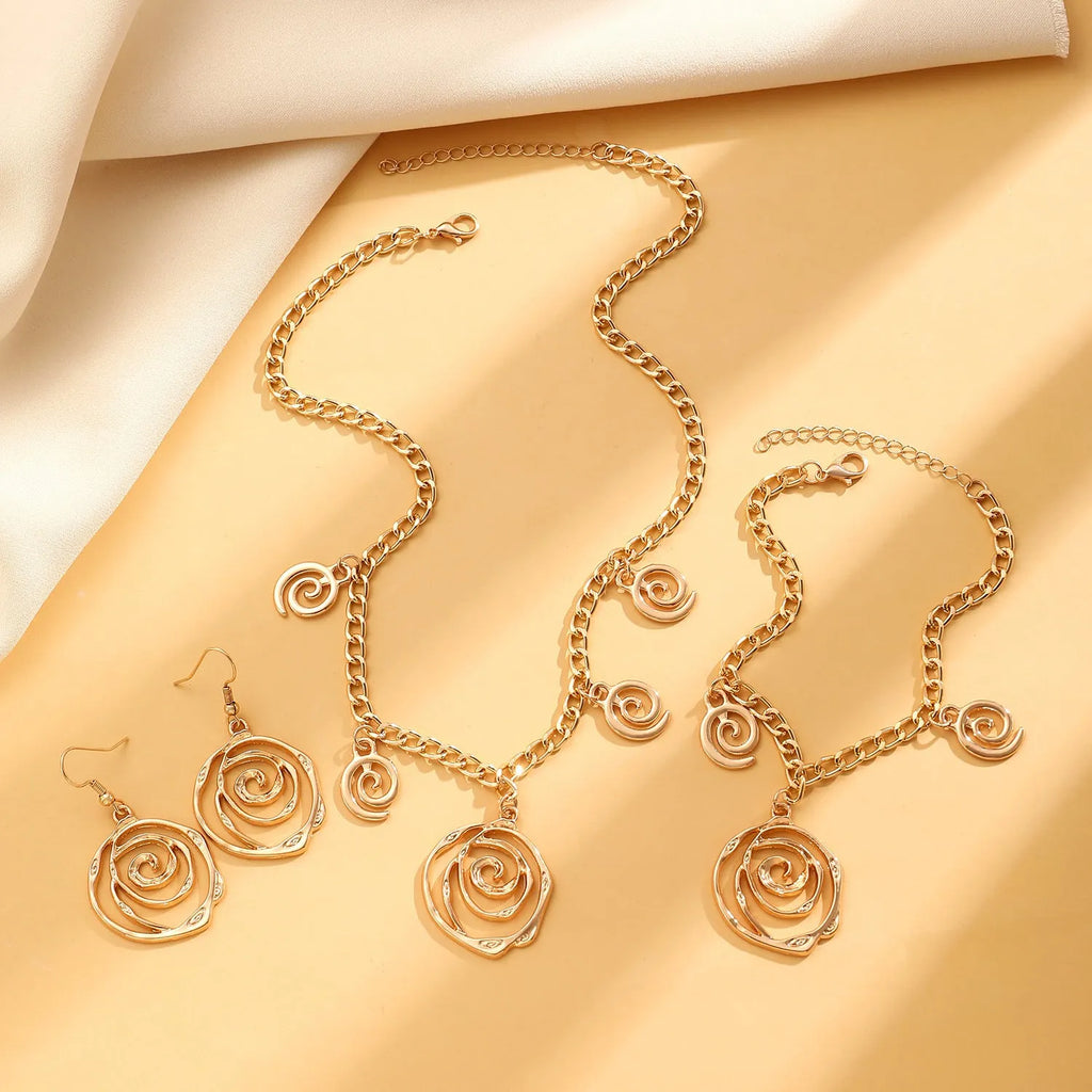 Spiral donut jewellery set showing necklace, bracelet and earrings in gold colour with geometry shapes