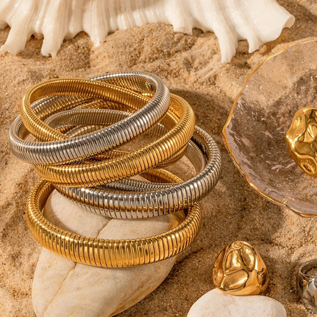 Women's titanium steel elastic bracelet with vertical stripe ring pattern in gold electroplated finish