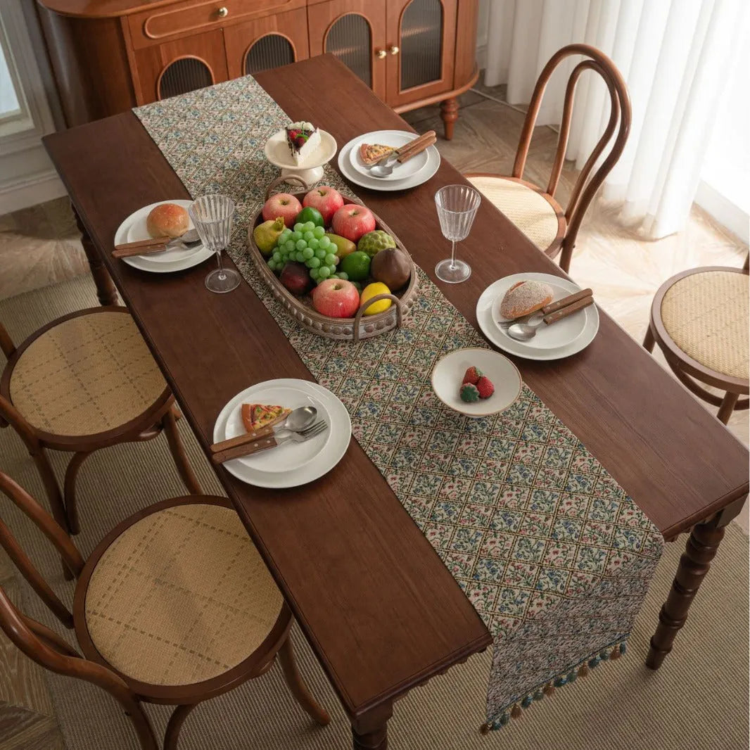 Dark blue Nordic jacquard table flag with striped bouquet pattern and tassel fringe on a wooden table.