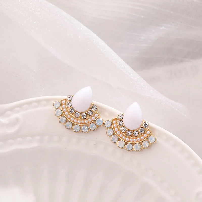 Women's retro fan-shaped silver needle earrings with rhinestone detailing on a geometric design.