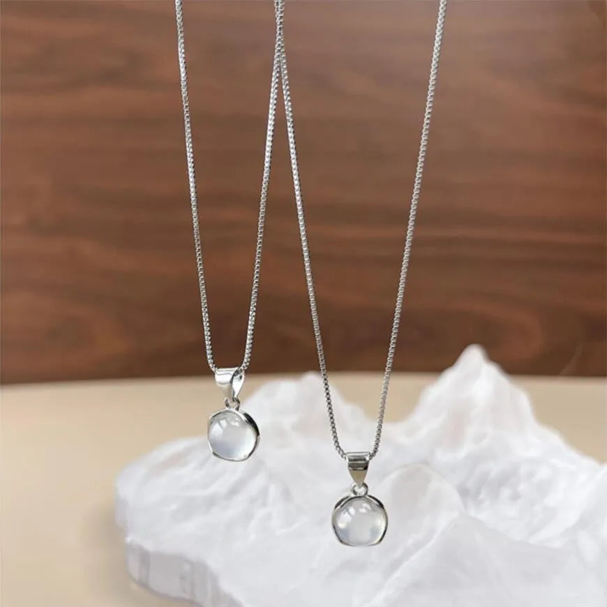 Women's oval pendant necklace with artificial crystal and eight-point star on adjustable silver-toned chain