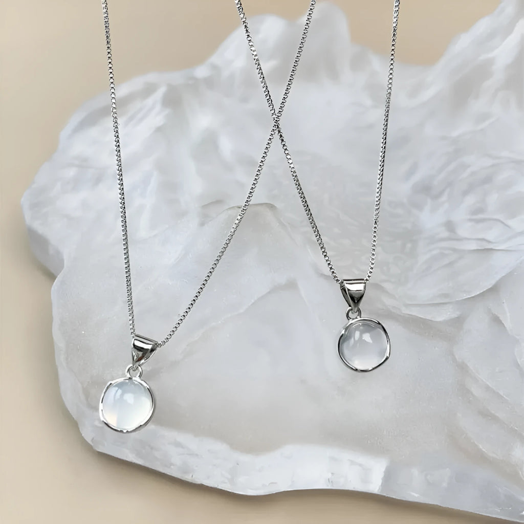 Women's oval pendant necklace with artificial crystal and eight-point star on adjustable silver-toned chain