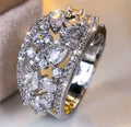 Women's hollow round copper fashion ring showing gold and platinum finish options with white and blue stone effects