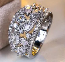 Women's hollow round copper fashion ring showing gold and platinum finish options with white and blue stone effects