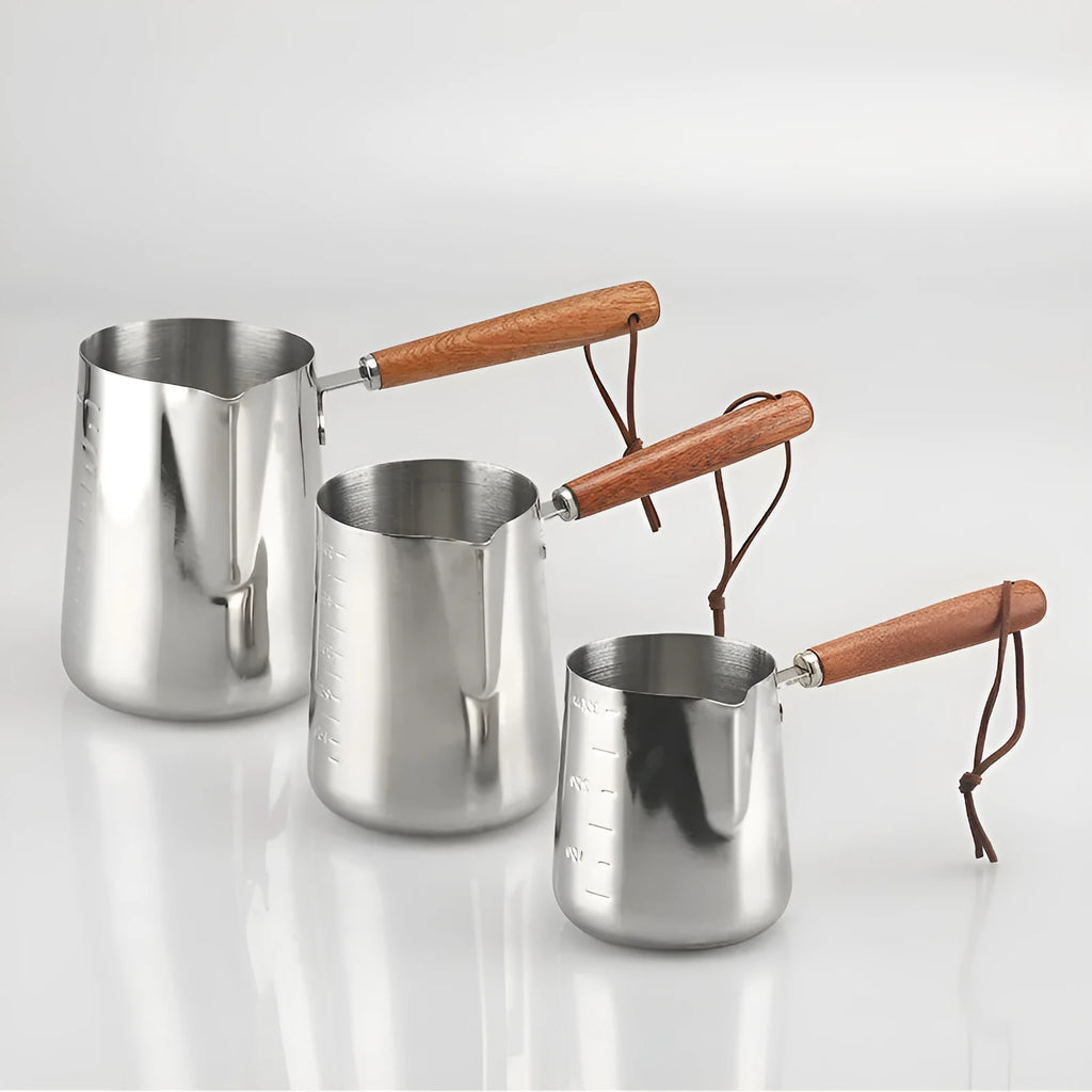 Stainless steel coffee cup with wooden handle showing interior measurement scale markings