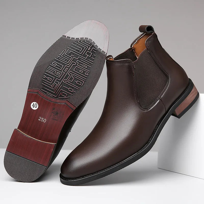 Men's black Chelsea high-top boots with a pointed toe and low rubber sole on a white background.
