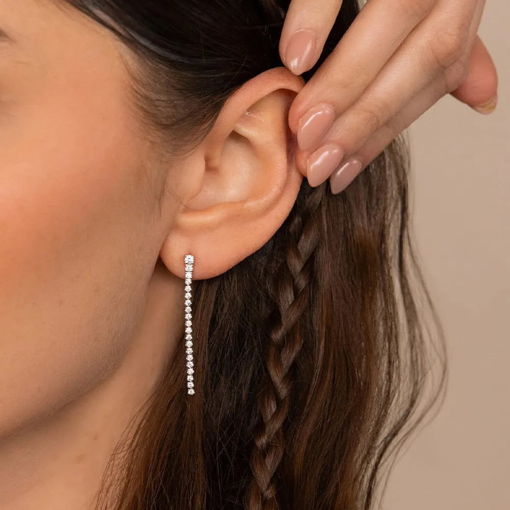 Geometric stainless steel zircon earrings in gold and steel colour on a white background.