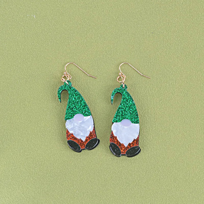 A pair of cartoon Santa Claus acrylic fashion earrings on a red background.