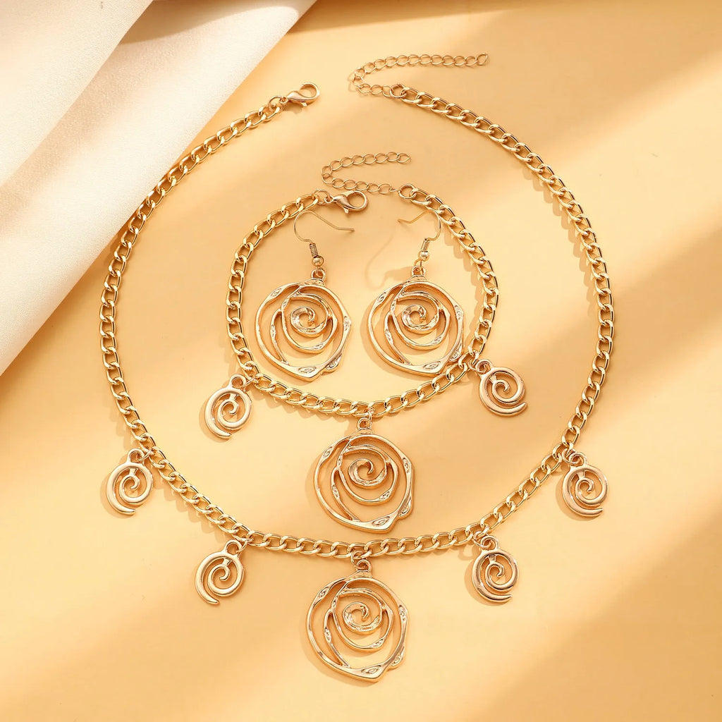 Spiral donut jewellery set showing necklace, bracelet and earrings in gold colour with geometry shapes