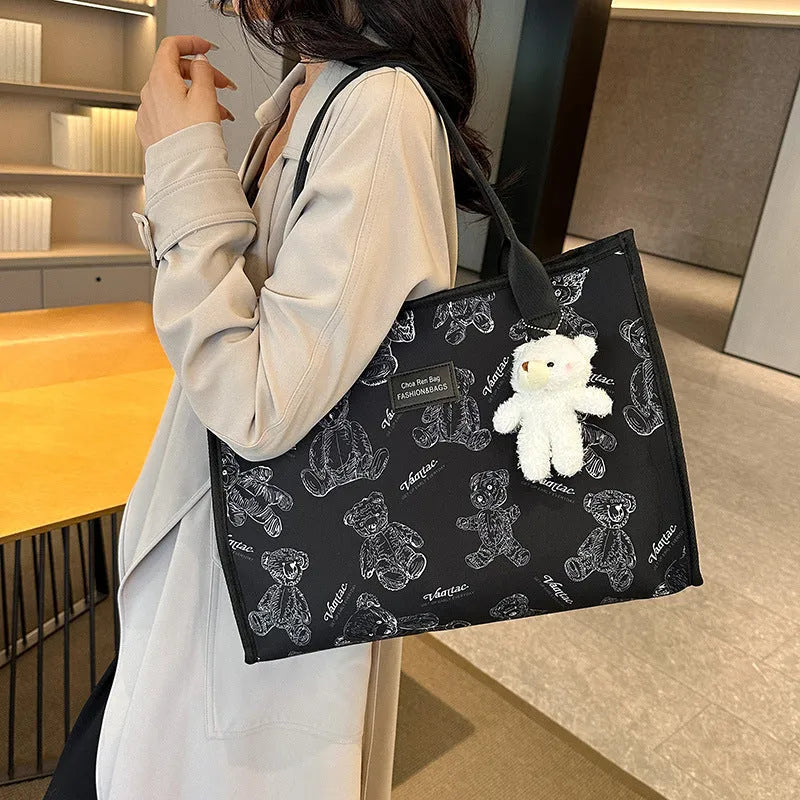 Women's black and white canvas tote bag with diamond pattern and sandwich pocket