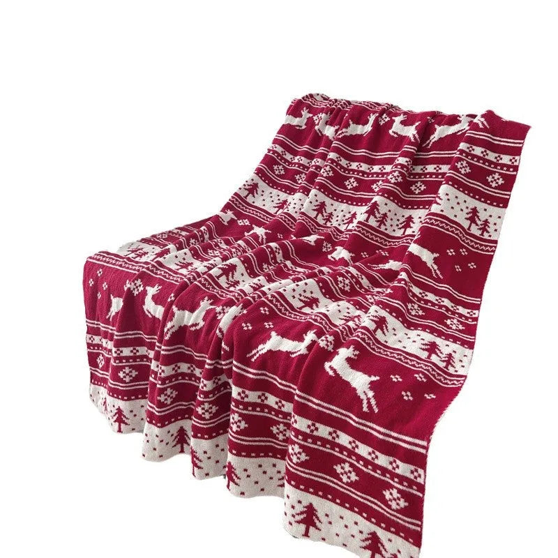 Personalised Christmas blanket with cartoon reindeer pattern, folded to show its soft acrylic texture.