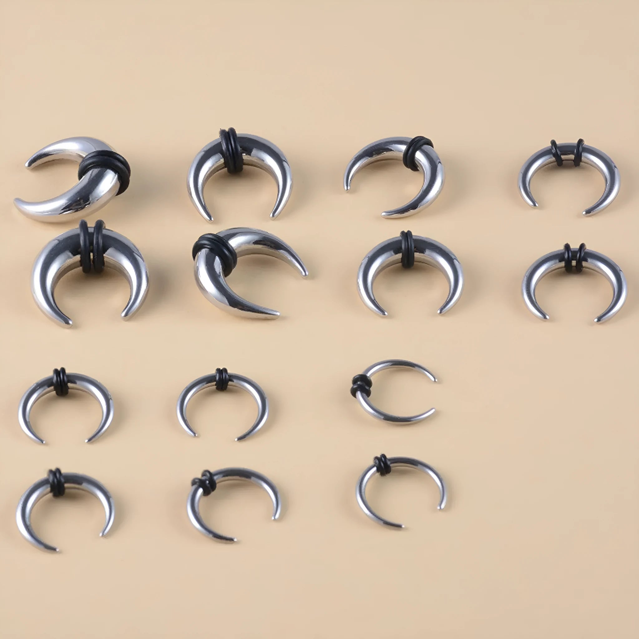 Curved C-shaped nose ring combining stainless steel and a brown buffalo horn segment.