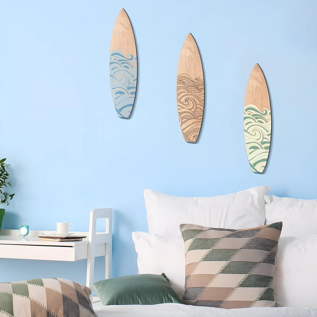 Set of three wooden surfboard-shaped wall decorations on a light background.