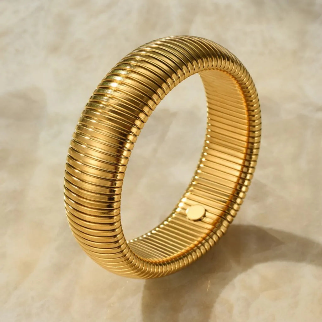 Women's titanium steel elastic bracelet with vertical stripe ring pattern in gold electroplated finish