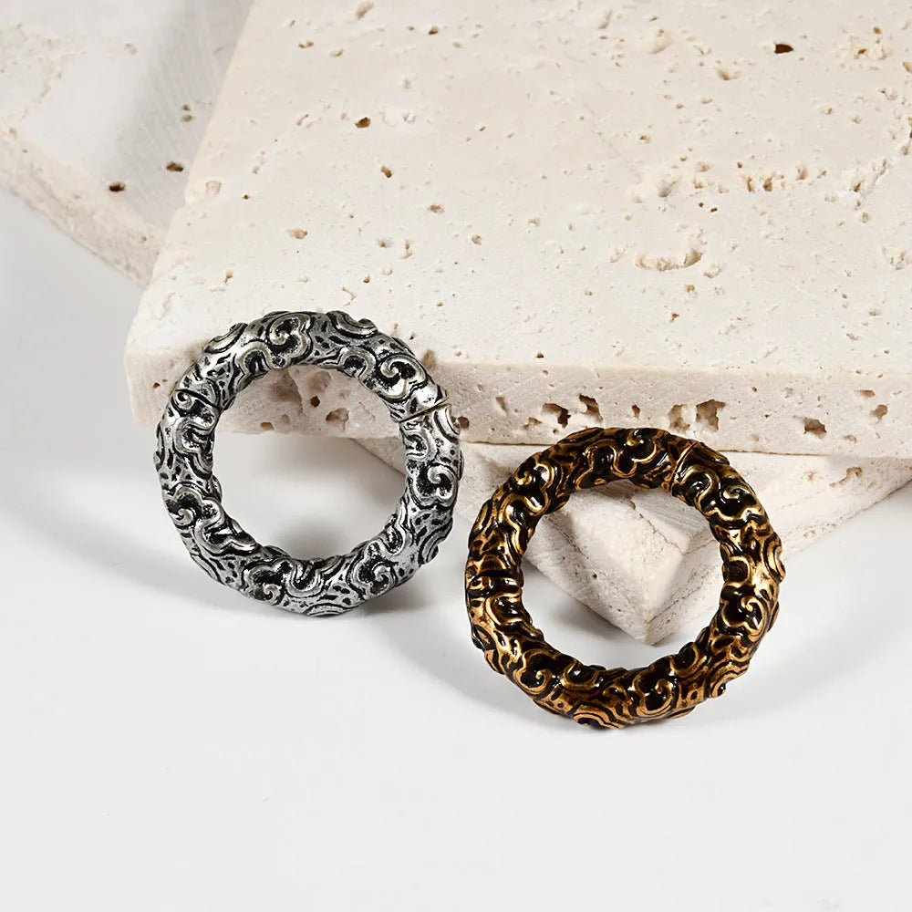 A pair of stainless steel fashion earrings with a shaped totem pattern, shown in one of fifteen available colour options.