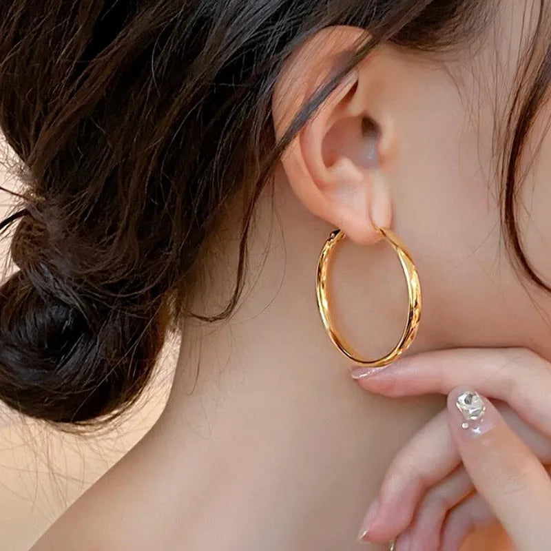 Metal circle earrings with gold or silver electroplated finish measuring 40mm diameter