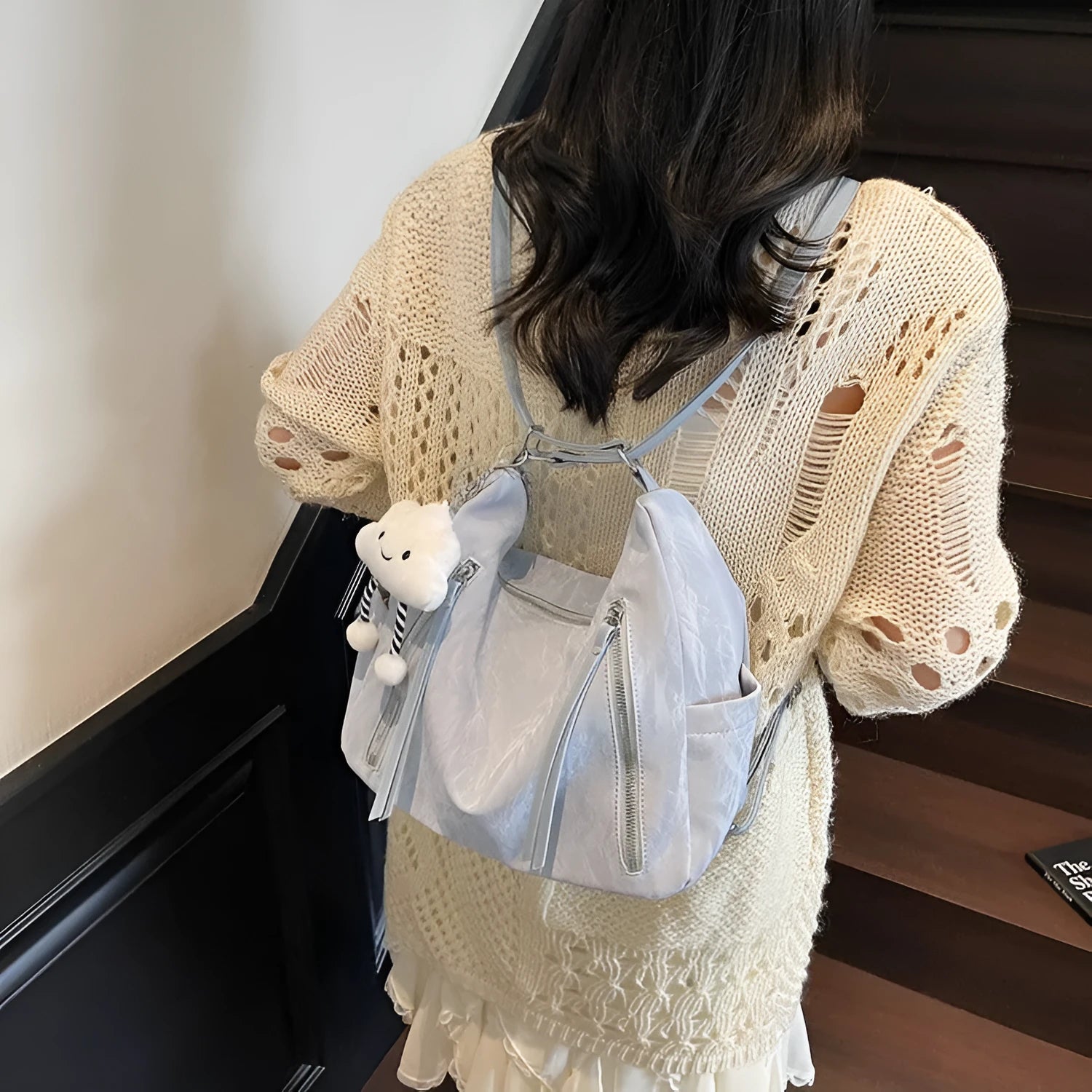 Women's PU leather fashion backpack in beige, black, blue, or silver with pendant accessory