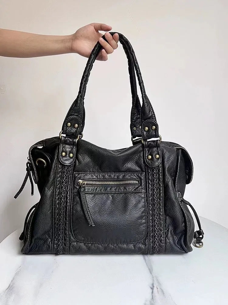 Women's retro motorcycle shoulder bag in bright black with golden edge or brown, showing internal compartments and slit pockets