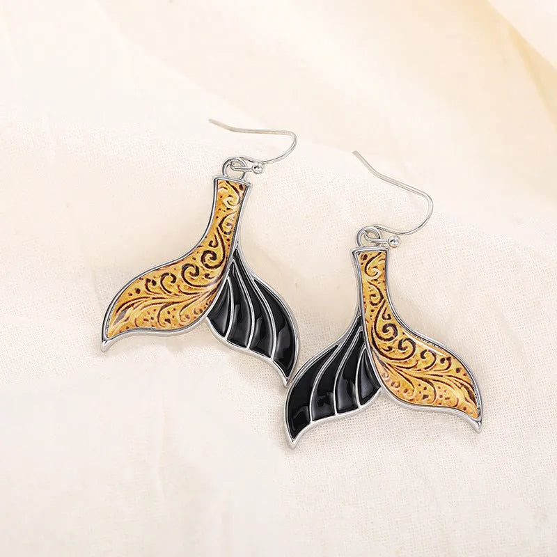 White gold colour alloy fishtail earrings with whale motif retro design