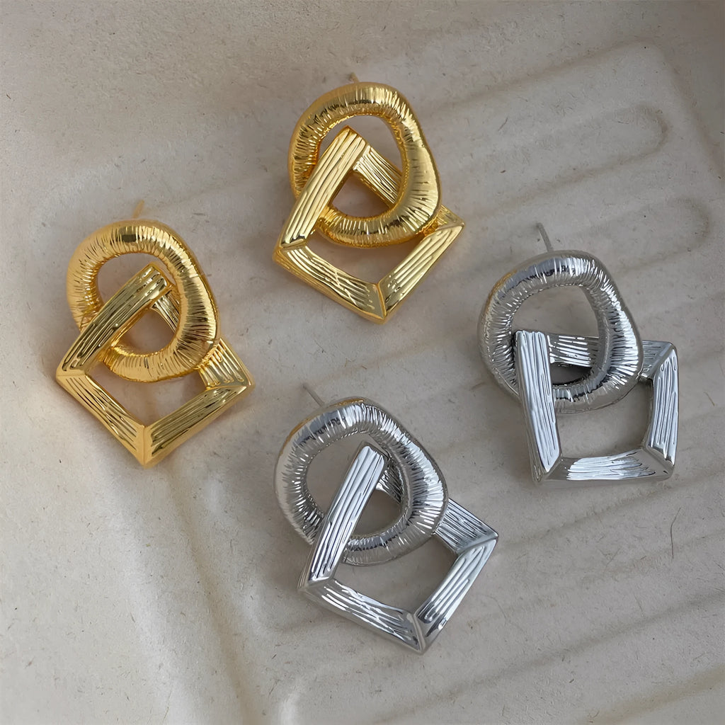A pair of retro-style geometric circle drop earrings in a gold tone with a 3.4cm pendant length.