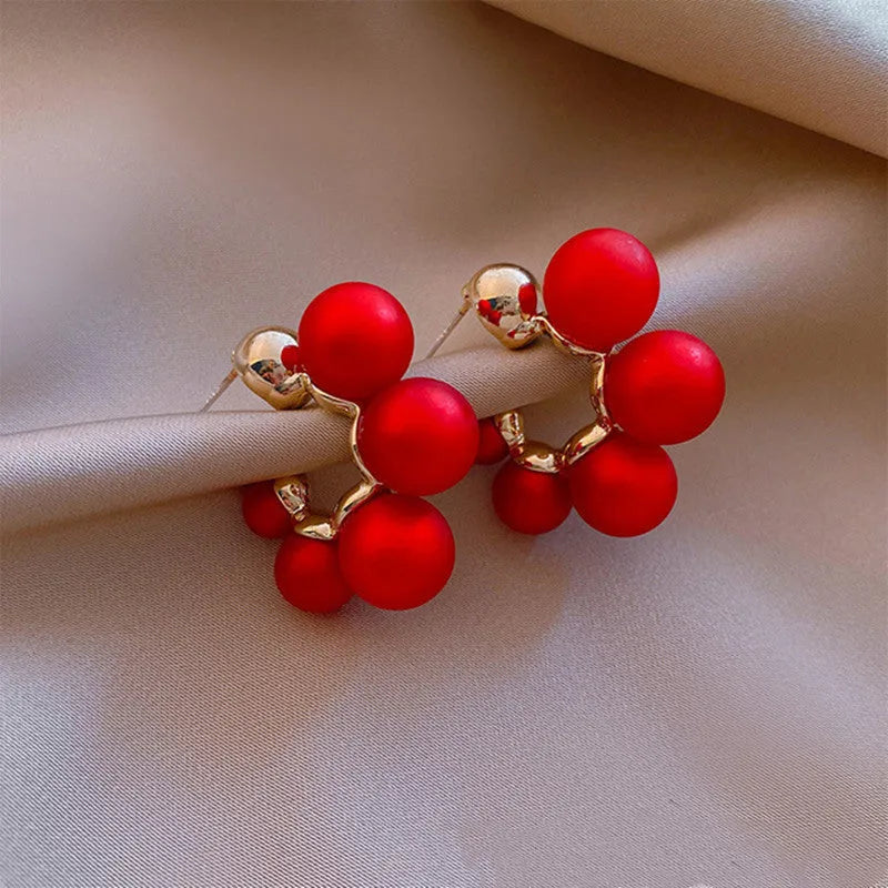 Red bell-shaped alloy earrings for women, also available in white.