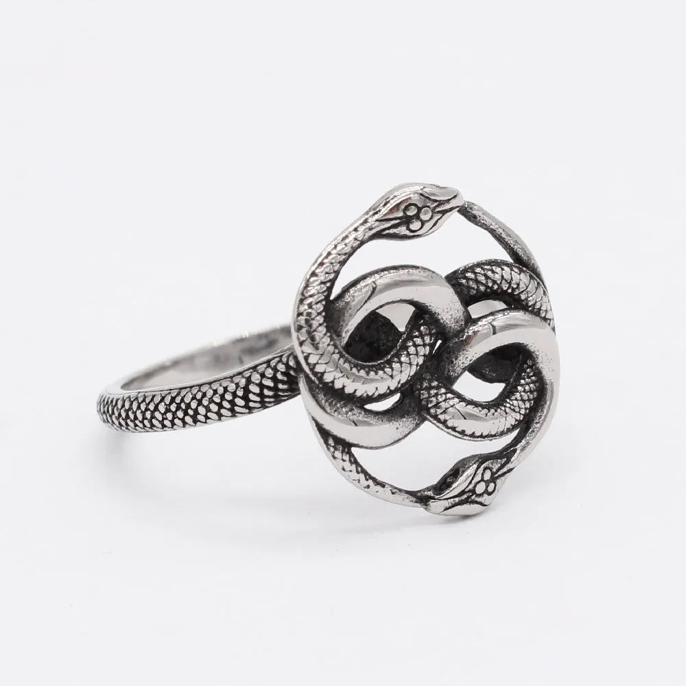 Close-up of a titanium steel double snake ring in a steel colour on a hand.