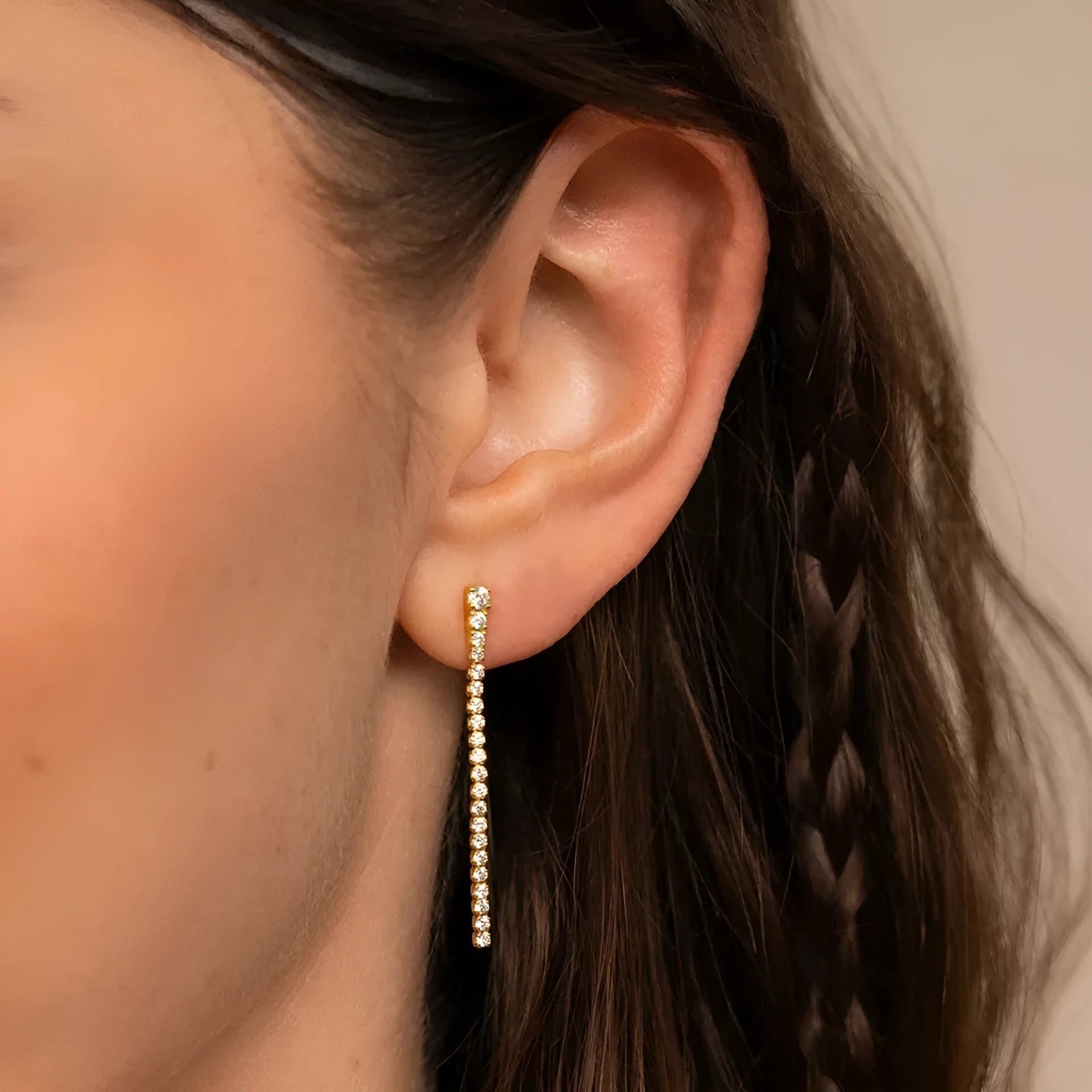 Geometric stainless steel zircon earrings in gold and steel colour on a white background.