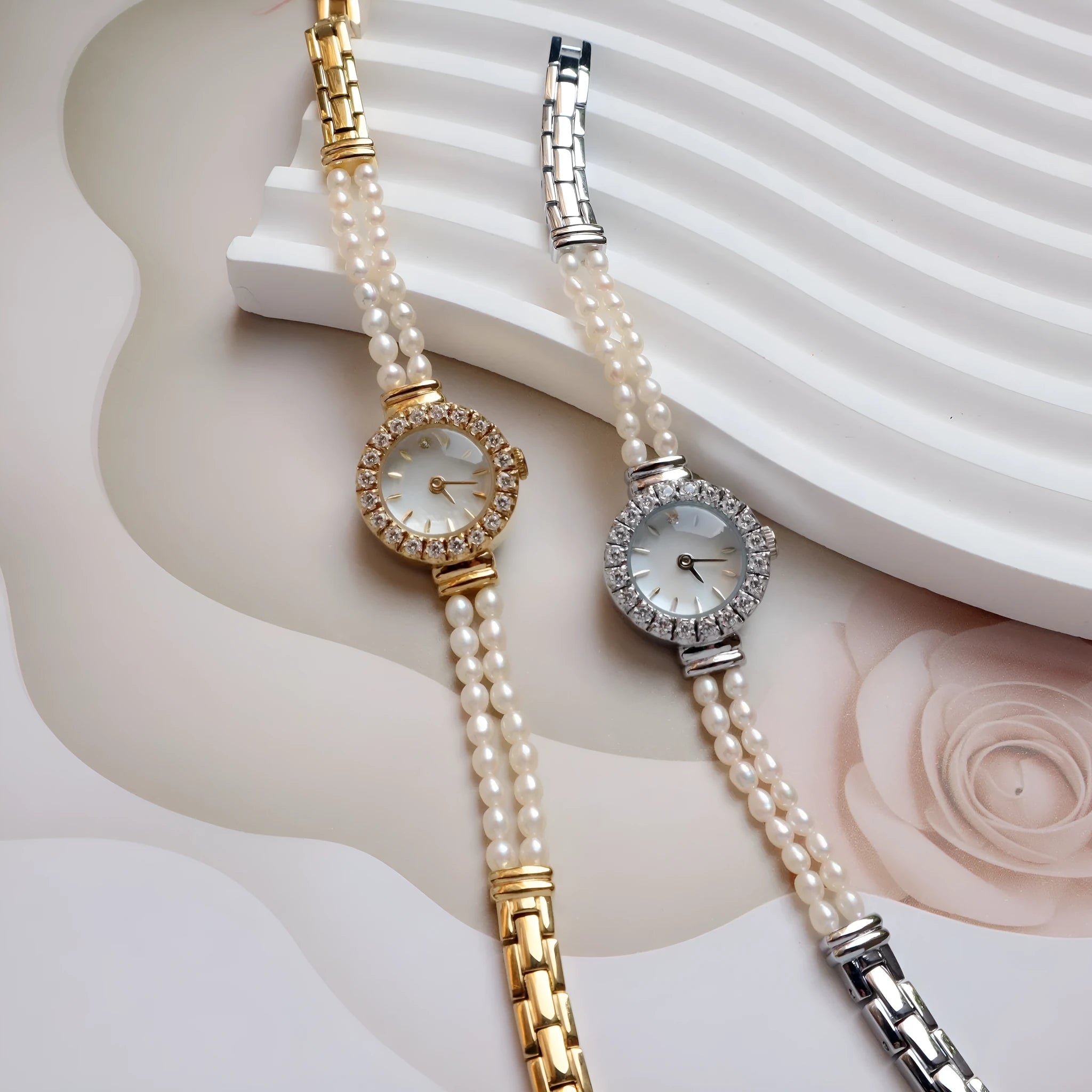 Women's light gold bracelet watch with freshwater pearls on stainless steel strap and 18mm dial.